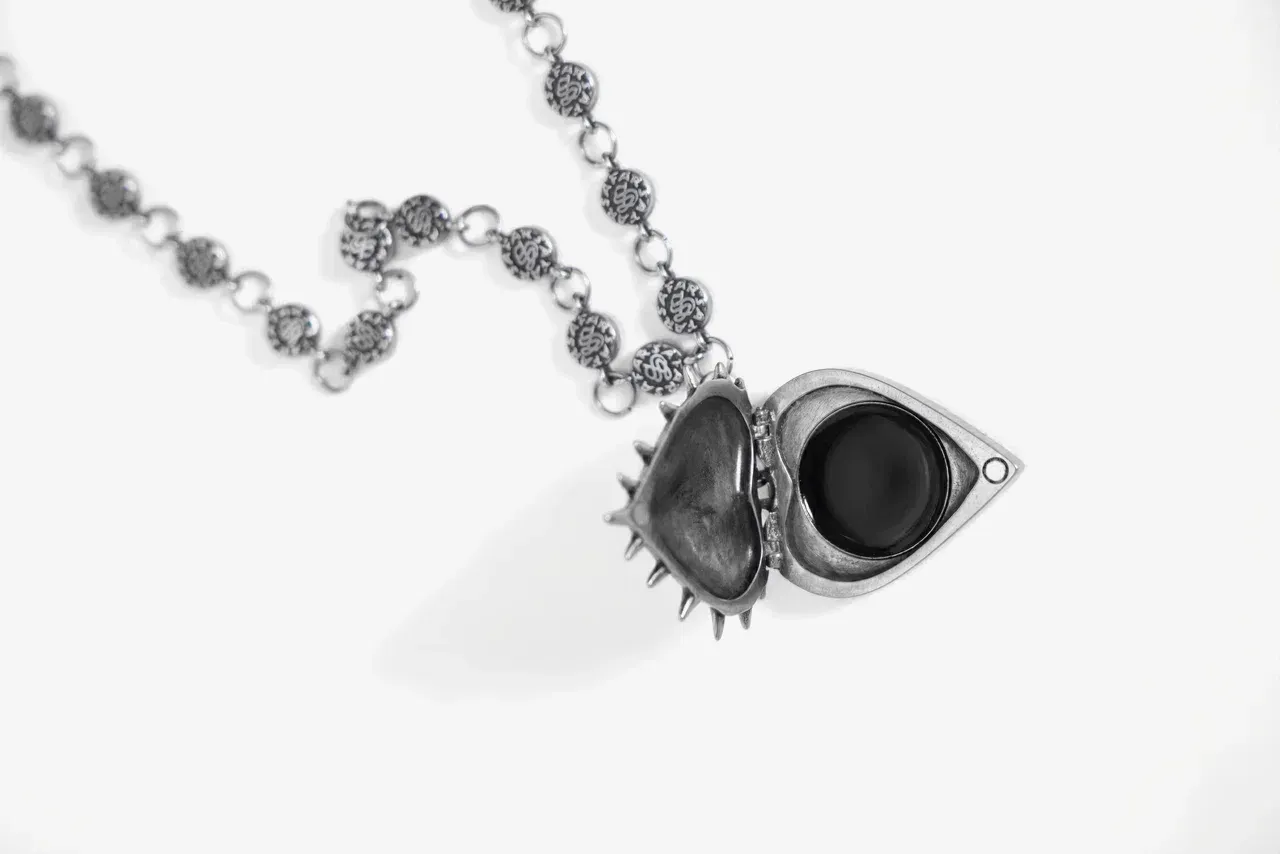 Open heart locket pendant with chain, close-up